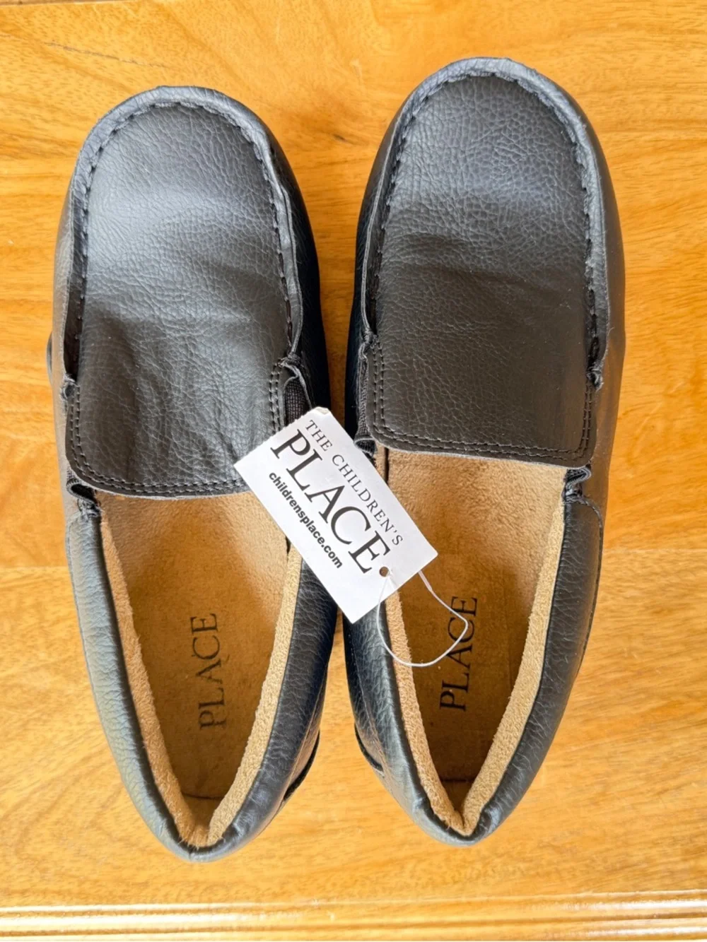 The Children's Place Black Slip-On moccasins.